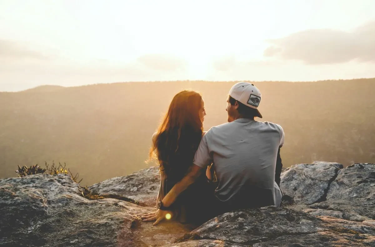 A happy couple sitting in nature